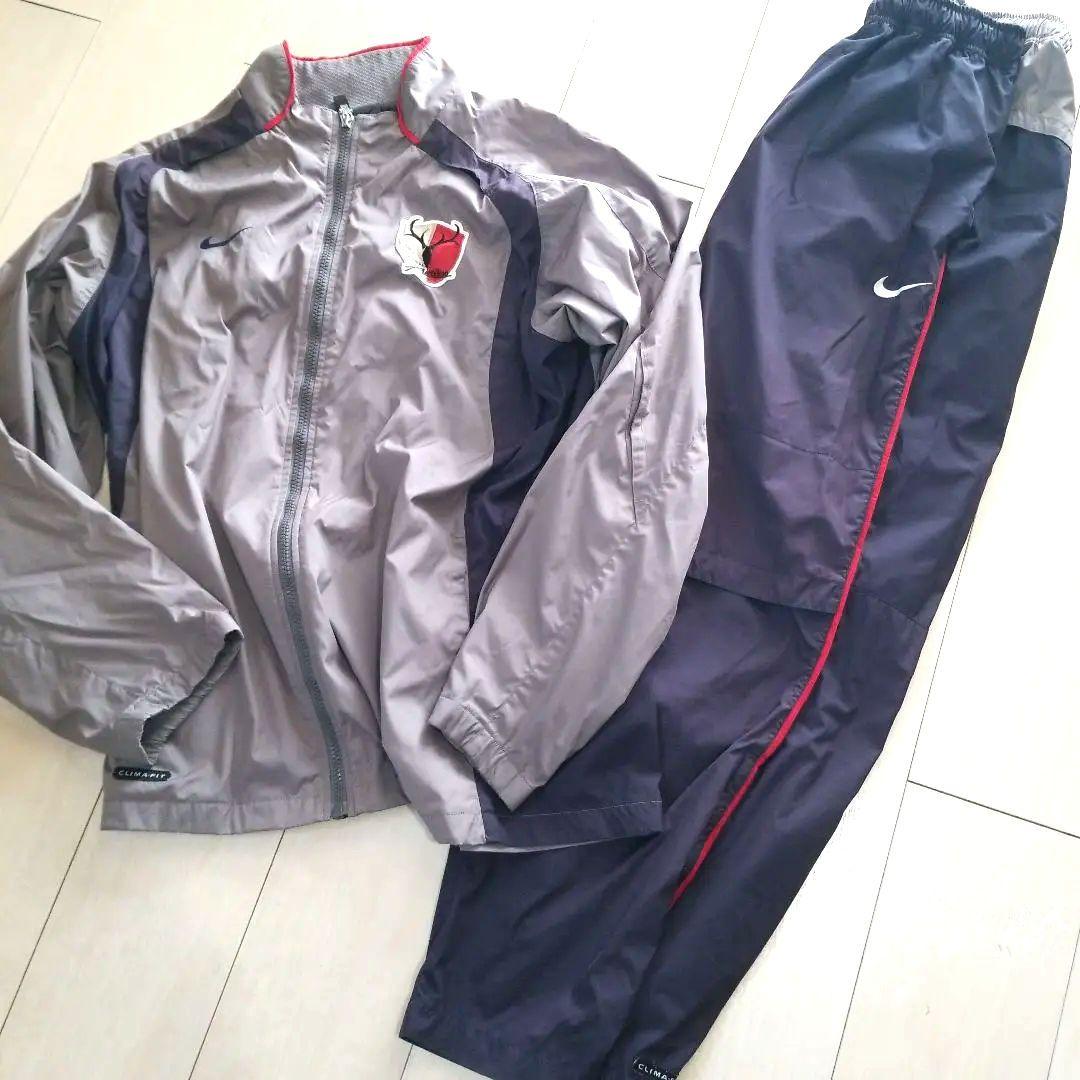 Nike ピステ・ウィンドブレーカー グレー/ネイビー　鹿島アントラーズ 2026年最新】アントラーズ ウィンドブレーカーの人気アイテム - メルカリ
